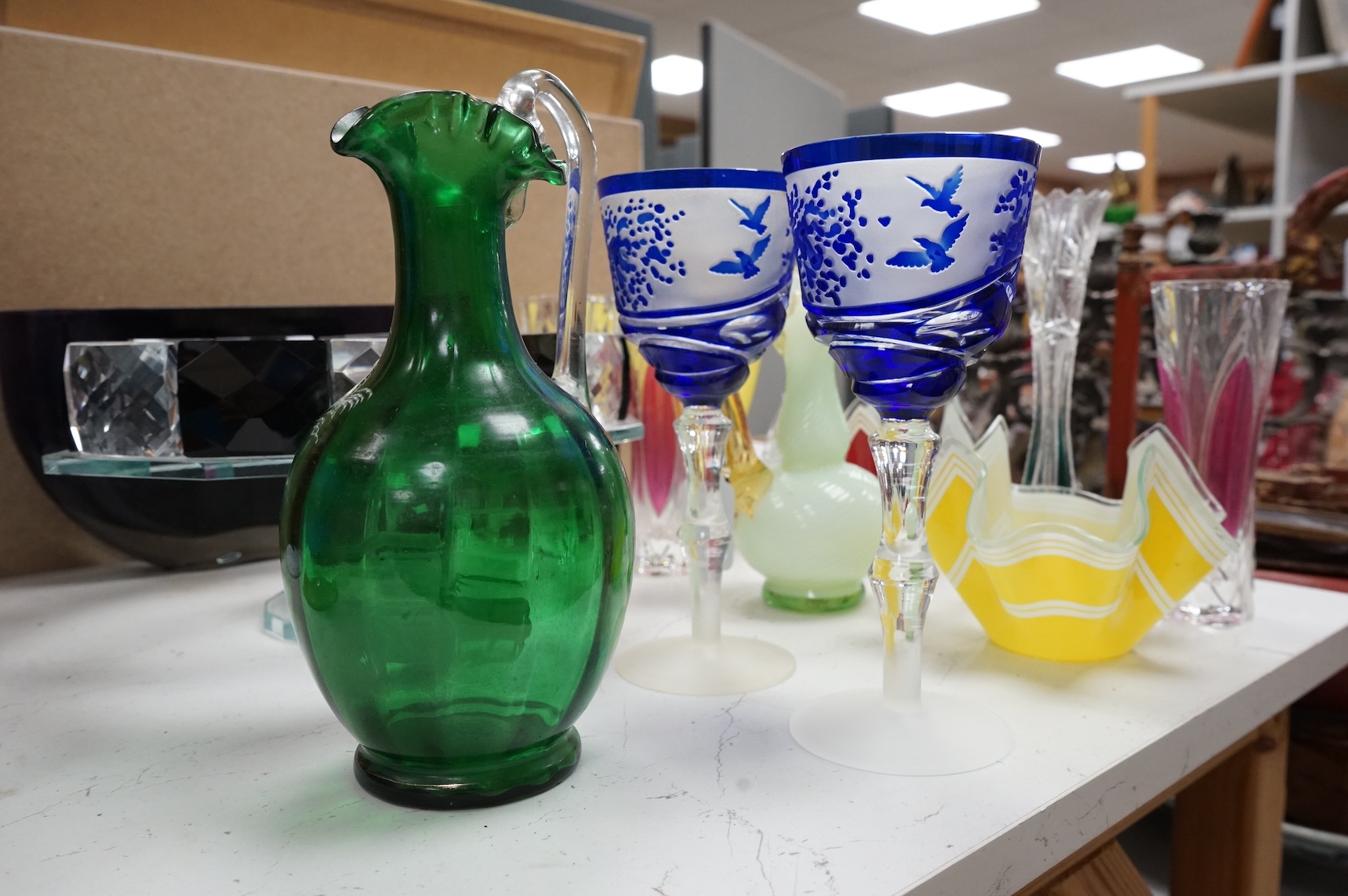 Mixed glassware to include a green Mary Gregory jug, a 'vaseline' glass ewer, an Art Deco style clear and black glass fruit tazza, etc.